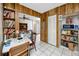 Cozy dining nook with built-in shelving, wood-paneled walls, and a ceiling fan at 8385 81St St, Seminole, FL 33777