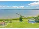 Aerial view of waterfront park with pier, stage, and playground at 102 Shore E Dr, Oldsmar, FL 34677