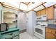 Bright kitchen featuring white appliances and a charming vintage cabinet at 11485 Oakhurst Rd # 1200-217, Largo, FL 33774