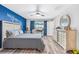 Spacious main bedroom with a stylish dresser and blue accent wall at 11914 Wild Daffodil Ct, Riverview, FL 33579