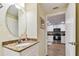 Cozy bathroom with granite countertops, leading into the bright, white kitchen at 12000 Gulf Blvd # 212-N, Treasure Island, FL 33706