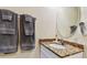 Well-lit bathroom with granite counters, a vessel sink, and towel racks at 12000 Gulf Blvd # 212-N, Treasure Island, FL 33706