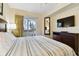 Comfortable bedroom with sliding doors to a balcony and a TV at 12000 Gulf Blvd # 212-N, Treasure Island, FL 33706