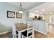 Open dining area with seating for six and views into the kitchen at 12000 Gulf Blvd # 212-N, Treasure Island, FL 33706
