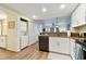Functional kitchen with a dishwasher, washer/dryer combo, and lots of cabinets at 12000 Gulf Blvd # 212-N, Treasure Island, FL 33706