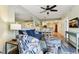 Cozy living room with a blue sofa, ceiling fan, and a dining area in the background at 12000 Gulf Blvd # 212-N, Treasure Island, FL 33706