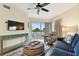 Cozy living room features a comfortable sofa and a sliding door to a balcony at 12000 Gulf Blvd # 212-N, Treasure Island, FL 33706