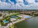 Aerial view of community with resort-style pool, tennis courts, and clubhouse at 140 Riviera Dunes Way # 1001, Palmetto, FL 34221