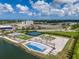 Aerial view of community with resort-style pool and tennis courts at 140 Riviera Dunes Way # 1001, Palmetto, FL 34221