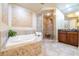 Bathroom features a corner soaking tub, walk-in shower, and modern vanity at 140 Riviera Dunes Way # 1001, Palmetto, FL 34221