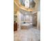 Spa-like bathroom with a large soaking tub, shower, and elegant tile at 140 Riviera Dunes Way # 1001, Palmetto, FL 34221