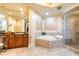 Bathroom boasts a soaking tub, shower, and dark wood cabinets at 140 Riviera Dunes Way # 1001, Palmetto, FL 34221