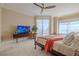 Serene bedroom with a king-size bed and a large TV at 140 Riviera Dunes Way # 1001, Palmetto, FL 34221