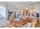 Bright dining area with wood table and chairs, adjacent to the kitchen at 140 Riviera Dunes Way # 1001, Palmetto, FL 34221