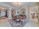 Elegant dining room with chandelier and view into kitchen at 140 Riviera Dunes Way # 1001, Palmetto, FL 34221