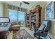 Bright home office features built-in shelving,water views, and comfortable seating at 140 Riviera Dunes Way # 1001, Palmetto, FL 34221