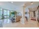 Spacious living room with water view and elegant furnishings at 140 Riviera Dunes Way # 1001, Palmetto, FL 34221