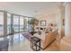 Bright living room with water view and elegant sofa at 140 Riviera Dunes Way # 1001, Palmetto, FL 34221