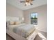 Bright bedroom features natural light and a neutral color scheme at 14426 Woodland Spur Dr, Lithia, FL 33547