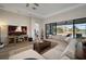 Living room with sectional sofa, fireplace TV, and pool views from sliding doors at 14426 Woodland Spur Dr, Lithia, FL 33547