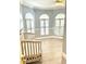 Bright bedroom with arched windows, plantation shutters, and wood-look flooring at 18007 Malakai Isle Dr, Tampa, FL 33647