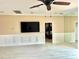 Living room with ceiling fan, wood-look tile, and a large wall mirror at 18007 Malakai Isle Dr, Tampa, FL 33647