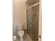 Bathroom with a toilet, shower, and tiled walls at 2165 Corbin Pl # A, Palm Harbor, FL 34683