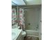 Bathroom with a bathtub/shower combo, a vanity, and a floral shower curtain at 2165 Corbin Pl # A, Palm Harbor, FL 34683