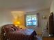 Bedroom with a comfortable bed, bedside table, and a window with curtains at 2165 Corbin Pl # A, Palm Harbor, FL 34683
