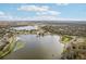 Aerial view of lake and surrounding landscape at 3022 Beaver Pond Trl, Valrico, FL 33596