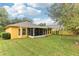 Large backyard with screened patio and grassy area at 3022 Beaver Pond Trl, Valrico, FL 33596