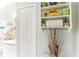 Bathroom linen closet with shelves and decorative accents at 3022 Beaver Pond Trl, Valrico, FL 33596