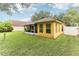 Back of house with screened patio and grassy backyard at 3022 Beaver Pond Trl, Valrico, FL 33596