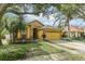 House front view with two-car garage and palm trees at 3022 Beaver Pond Trl, Valrico, FL 33596