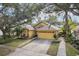 House front view, featuring a two-car garage and manicured lawn at 3022 Beaver Pond Trl, Valrico, FL 33596