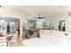 Open concept kitchen and living area with vaulted ceilings and neutral decor at 3022 Beaver Pond Trl, Valrico, FL 33596
