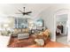 Bright living room with hardwood floors, large TV, and comfy furniture at 3022 Beaver Pond Trl, Valrico, FL 33596