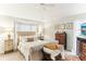 Relaxing main bedroom with plush bed, ample natural light, and decorative accents at 3022 Beaver Pond Trl, Valrico, FL 33596