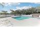 Community pool with surrounding lounge chairs at 3022 Beaver Pond Trl, Valrico, FL 33596