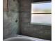 Modern tiled shower with mosaic accents and a frosted window for natural light at 413 Shannon Estates Ct, Plant City, FL 33563