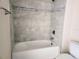 Bathroom featuring ceramic tile surround, shower, and tub combination with a new faucet at 413 Shannon Estates Ct, Plant City, FL 33563