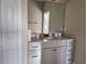 Elegant bathroom vanity with granite countertop, ample storage, and a large mirror at 413 Shannon Estates Ct, Plant City, FL 33563