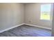 Neutral bedroom with grey flooring and a large window providing ample natural light at 413 Shannon Estates Ct, Plant City, FL 33563