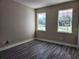 Bright bedroom with wood-look flooring and dual windows offering ample natural light at 413 Shannon Estates Ct, Plant City, FL 33563
