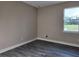 Bright bedroom with wood-look flooring and a window offering ample natural light at 413 Shannon Estates Ct, Plant City, FL 33563