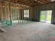 Interior under construction with block walls, stud framing, and sliding glass doors to the backyard at 413 Shannon Estates Ct, Plant City, FL 33563