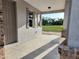 View of the spacious covered front porch with view of the yard and neighborhood at 413 Shannon Estates Ct, Plant City, FL 33563
