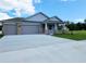 Charming single-Gathering home with a two-car garage, brick accents, and well-manicured lawn at 413 Shannon Estates Ct, Plant City, FL 33563