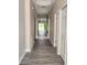 Long hallway with wood-style flooring leading to the living areas and bedrooms at 413 Shannon Estates Ct, Plant City, FL 33563