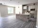 Open-concept kitchen featuring a brick island and stainless steel appliances at 413 Shannon Estates Ct, Plant City, FL 33563
